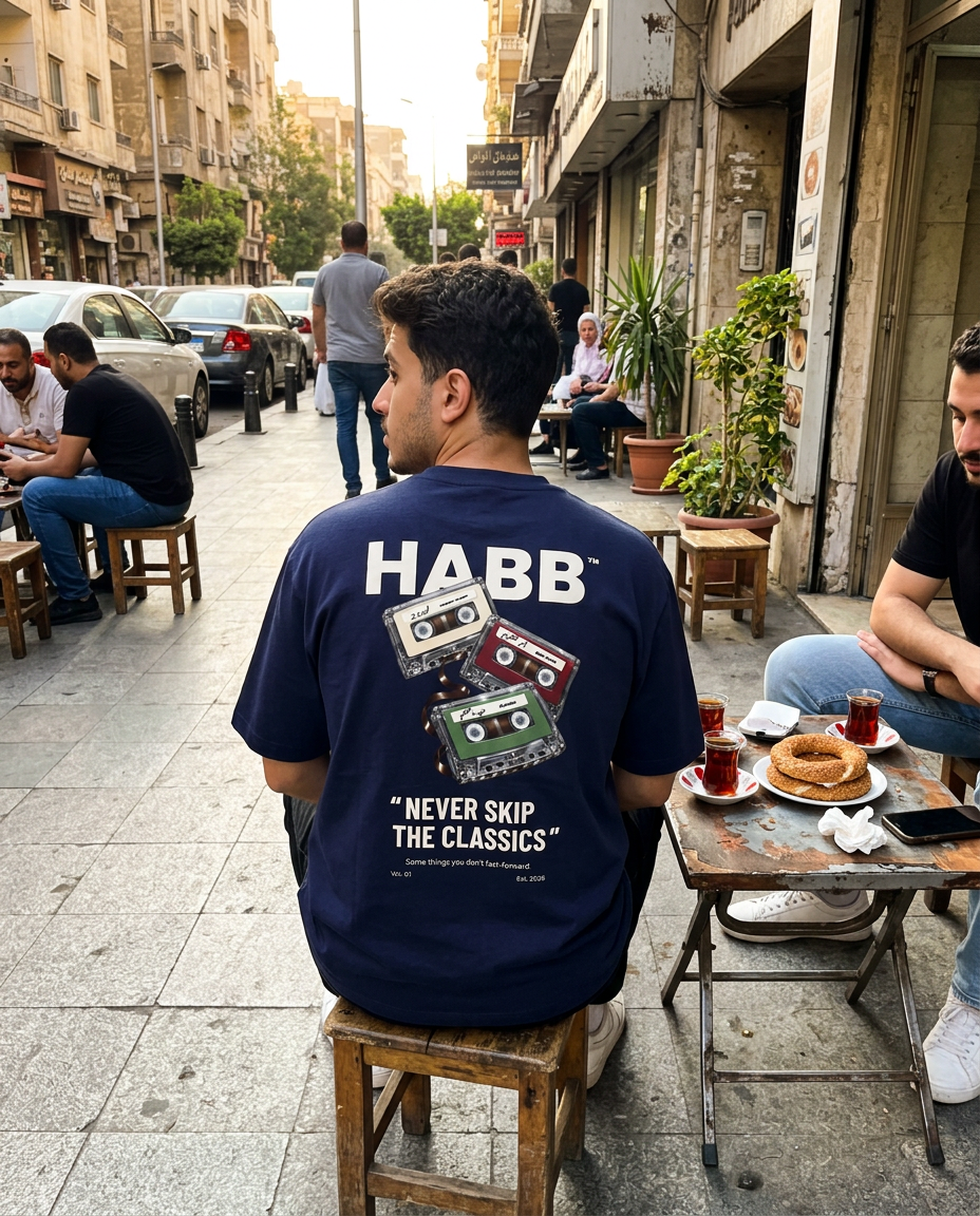 Wearing The Classics Tee in Navy at a street cafe